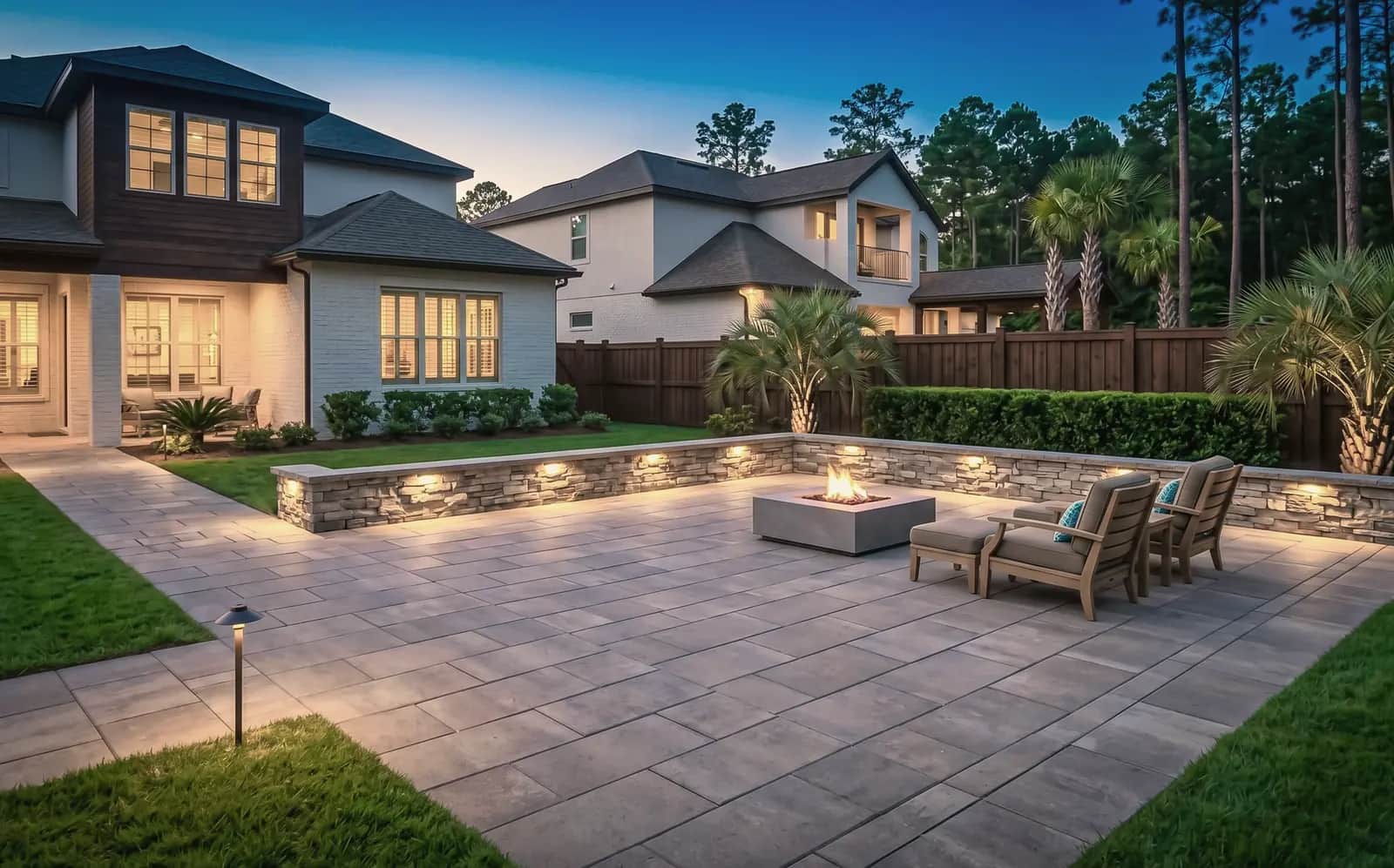 Paver patio with a low seating wall and a fire pit
